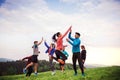 Large group of fit and active people jumping after doing exercise in nature. Royalty Free Stock Photo