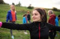 Large group of fit and active people stretching after doing exercise in nature. Royalty Free Stock Photo