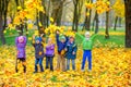 Large group of friends play in a beautiful autumn park Royalty Free Stock Photo