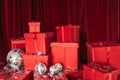 A large group of gift wrapped Christmas presents in colorful red wrapping paper with ribbons and bows, on a red background with c Royalty Free Stock Photo