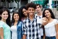 Large group of international young adults taking selfie with phone outdoor in the summer Royalty Free Stock Photo