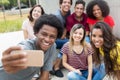 Large group of international young adults taking selfie with phone Royalty Free Stock Photo