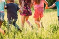 Large group of kids, friends boys and girls running in the park on sunny summer day in casual clothes . Royalty Free Stock Photo