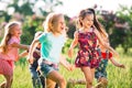 Large group of kids, friends boys and girls running in the park on sunny summer day in casual clothes . Royalty Free Stock Photo