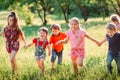 Large group of kids, friends boys and girls running in the park on sunny summer day in casual clothes . Royalty Free Stock Photo