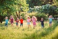 Large group of kids, friends boys and girls running in the park on sunny summer day in casual clothes . Royalty Free Stock Photo