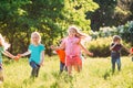 Large group of kids, friends boys and girls running in the park on sunny summer day in casual clothes . Royalty Free Stock Photo