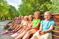 Large group of kids sitting on the bench Royalty Free Stock Photo