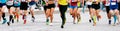 large group male and female runners run marathon