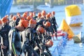 Large group of male triathletes wearing black swimsuit