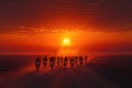 Silhouettes of Motorcyclists Riding Towards a Setting Sun on a Desert Road Royalty Free Stock Photo