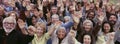 Large group of multi-ethnic people cheering with arms raised Royalty Free Stock Photo