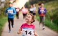 Large group of multi generation people running a race competition in nature. Royalty Free Stock Photo