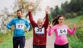 Large group of multi generation people running a race competition in nature. Royalty Free Stock Photo