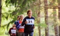 Large group of multi generation people running a race competition in nature. Royalty Free Stock Photo