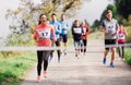 Large group of multi generation people running a race competition in nature. Royalty Free Stock Photo