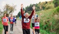 Large group of multi generation people running a race competition in nature. Royalty Free Stock Photo