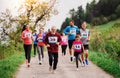 Large group of multi generation people running a race competition in nature. Royalty Free Stock Photo