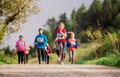 Large group of multi generation people running a race competition in nature. Royalty Free Stock Photo