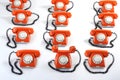 Large group of orange telephones