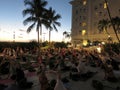 Large group of People do sunset yoga at Moana