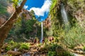 Large group of people enjoy waterfall descent using ropes Royalty Free Stock Photo