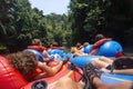 Large group of people floating down a scenic jungle river in Belize Central America on a natural Cave Tubing adventure