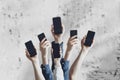 a large group of people hold digital phones device, many human hands