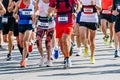 large group runners athletes men and women run city marathon race