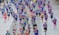 Large group of running girls and boys in blue