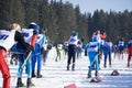 Large group of skiers on ski slopes in a mountain resort in winter