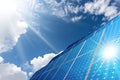 Large Group of Solar Panels on Blue Sky with Clouds and Sun Rays Royalty Free Stock Photo