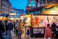 Large group tourists discovering the Christmas Market in central Strasbourg drinking mulled wine buying gifts with Royalty Free Stock Photo