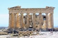 A large group of visitors admiring the Parthenon atop the Acropolis on a hot sunny day during a summer day in Athens