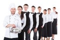 Large group of waiters and waitresses standing in row Royalty Free Stock Photo