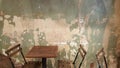 restaurant folding chairs and tables with distressed and chipping white green wall