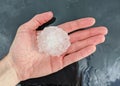 Large hailstone measuring greater than two inches sitting in a personÃ¢â¬â¢s hand. Royalty Free Stock Photo