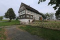 Large half timbered house with wooden roof and garden