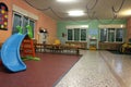 Large hall in a nursery with the plastic slide for kids