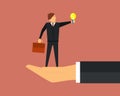 A large hand holds in the palms of a small office worker, employee or businessman in a suit with a glowing light bulb.