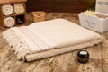 Large handwoven cotton bath towel on rustic wooden background
