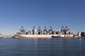 Large harbor cranes loading container ships in the port of Rotterdam