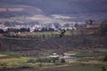 Large hawk soaring over valley villiage.