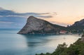 Large headland in the sea near the resort town in the Bay at sunset