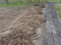 Large heap pile of construction soil mud land earth dirt heap pile, freshly digged, mixed with some horse manure dung Royalty Free Stock Photo