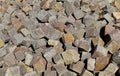 Large heap of porphyry cubes ready to be used for sidewalk or exterior pavement. Construction materials. Royalty Free Stock Photo