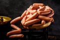 large heap of raw long thin wieners on antiquarian scales Royalty Free Stock Photo