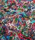 Large heap of women`s multicolored cheap necklaces. Fashion, background and texture