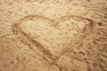 Heart shape drawn in sand of the sea beach for natural, symbol, tourism, holiday or conceptual designs. Royalty Free Stock Photo