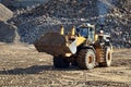 Large heavy front-end loader or all-wheel bulldozer for mechanization of loading, digging and excavation operations in open quarry Royalty Free Stock Photo